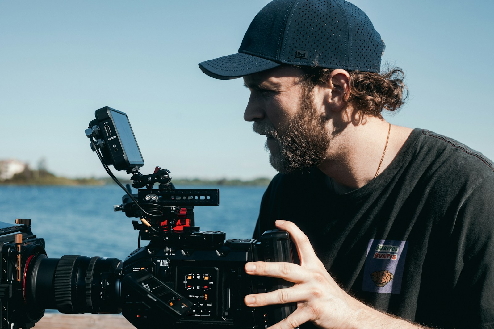 man in black crew neck t-shirt holding black dslr camera